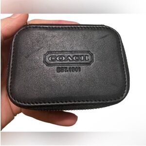Sleek vintage black leather pill pouch by Coach